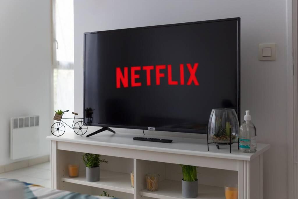 a television on a white table with anetflix sign on it at DÉPLACEMENT PRO &amp; TOURISME - NETFLIX - WIFI - Easy CHECK-IN in Bourg-la-Reine