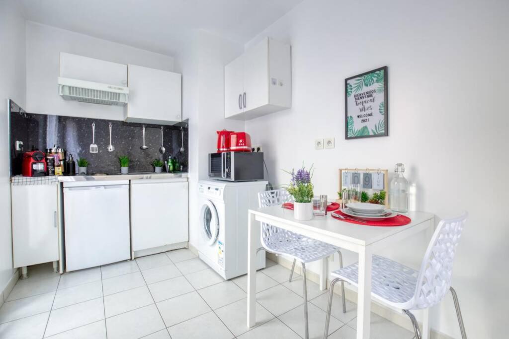 a kitchen with white cabinets and a white table and chairs at DÉPLACEMENT PRO &amp; TOURISME - NETFLIX - WIFI - Easy CHECK-IN in Bourg-la-Reine