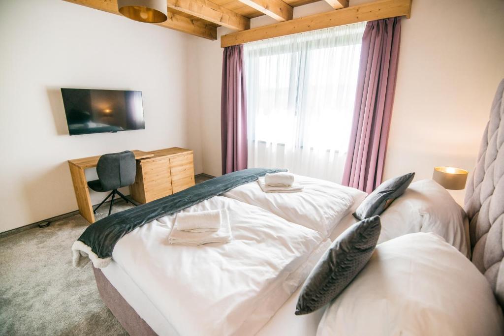 Posteľ alebo postele v izbe v ubytovaní Apartmány Tatry Žiarce