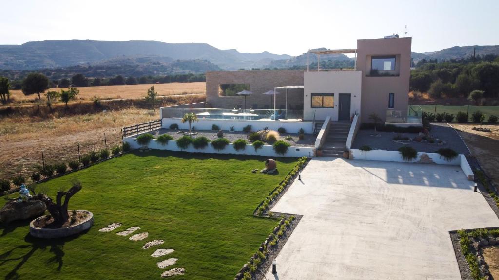 a house with a lawn in front of it at DS Luxury House in Kos