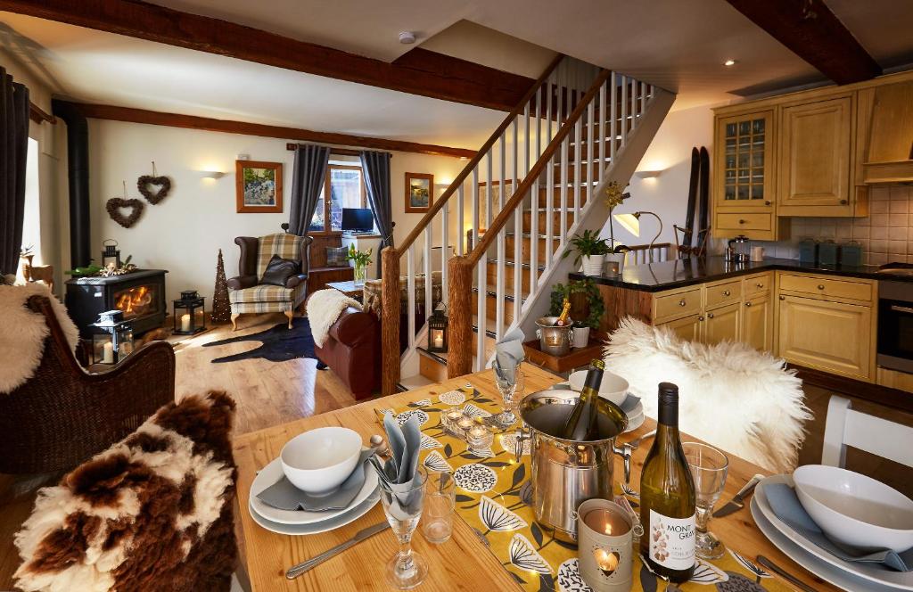 a kitchen with a wooden table and a staircase at Skivillaroger in Villaroger