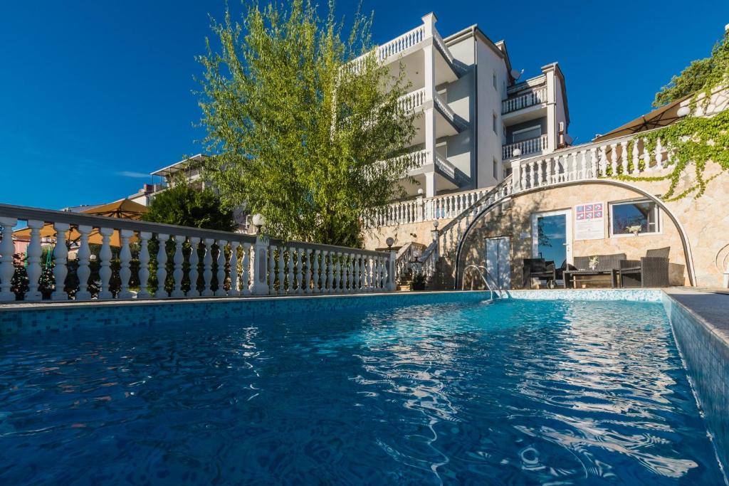 a swimming pool in front of a building at Villa Mara in Crikvenica