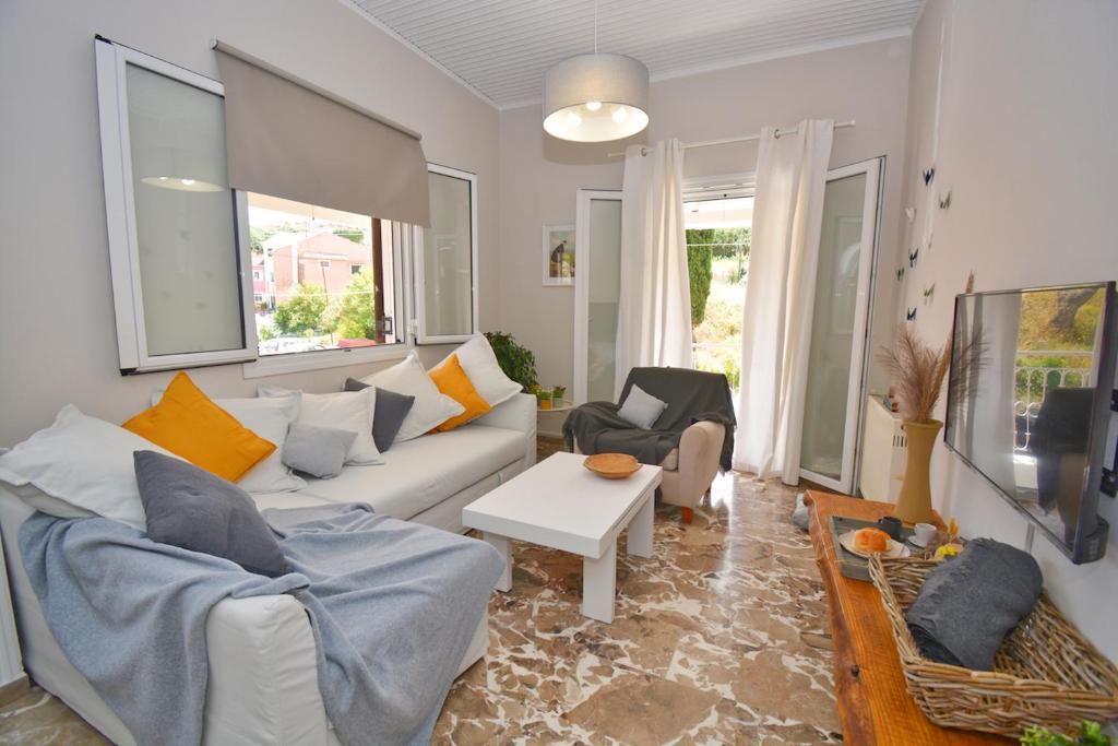 a living room with a couch and a table at Yia Sou Corfu! "Kolibri" in Sinarádes