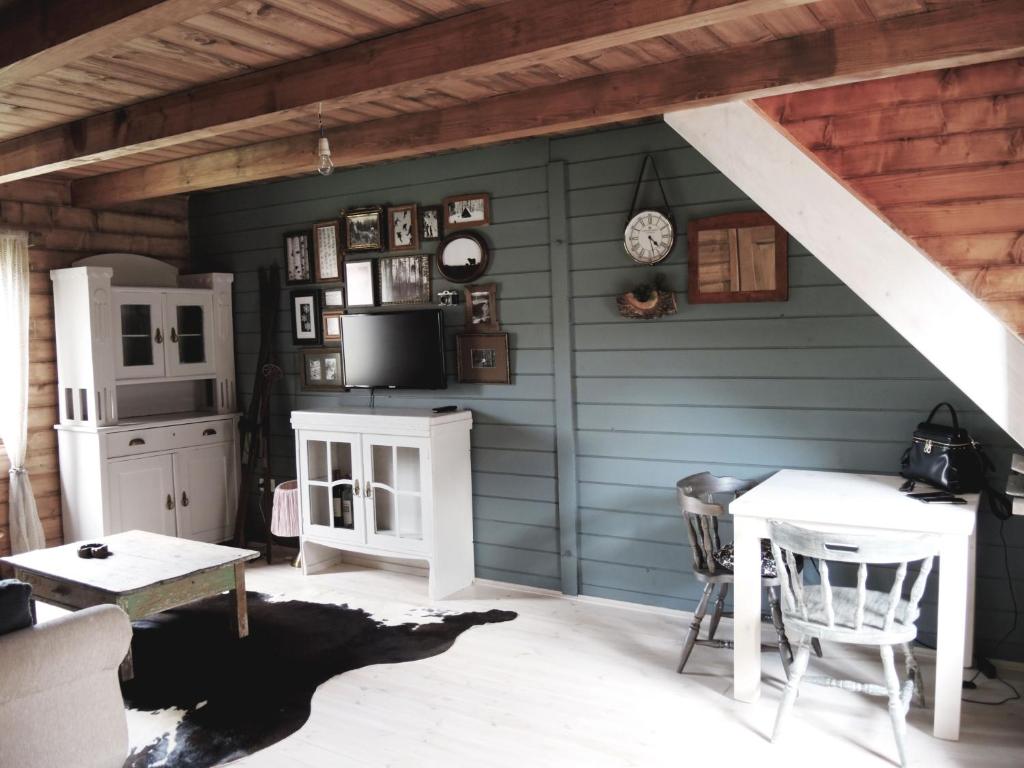 a room with a blue wall with a table and chairs at Chalet Lily in Žabljak