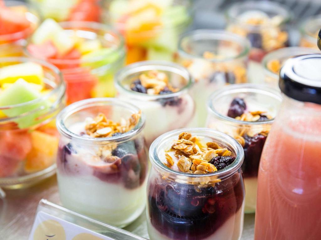 a group of cups filled with different types of food at Novotel Newcastle Beach in Newcastle
