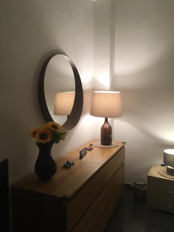 a dresser with a lamp and a mirror on it at Blackboard House in Bari