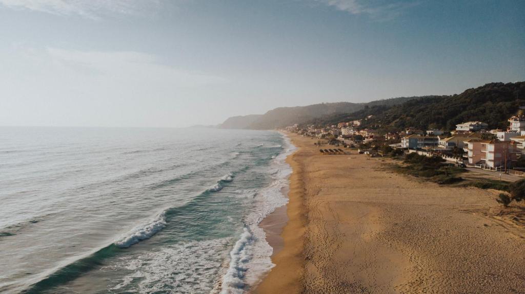 a view of a beach with houses and the ocean at Casa Costa Suites in Kanali