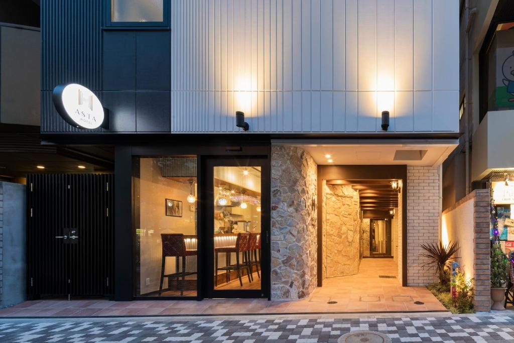 a house with a clock on the side of it at Asta Hotel in Tokyo