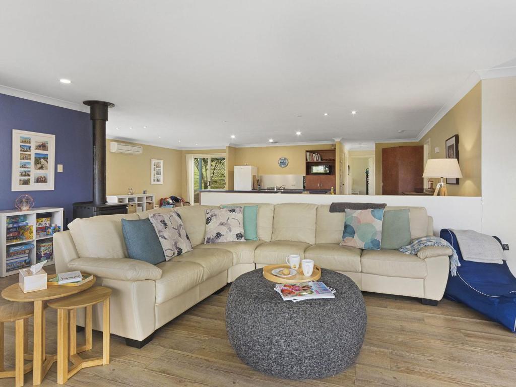 a living room with a couch and a table at 1 Bennett Court in Carrickalinga