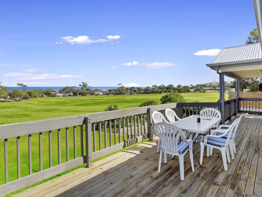 a wooden deck with a table and chairs on it at Carried Away 9 Dorset Court in Carrickalinga