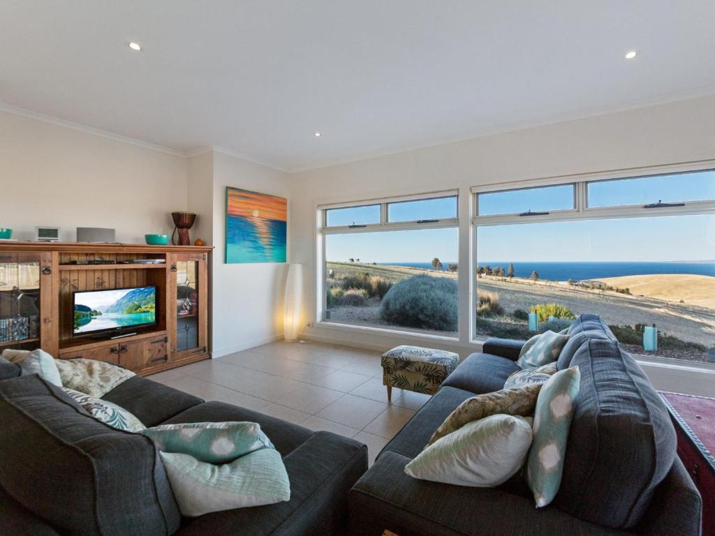 a living room with two couches and a tv at Fleurieu Coastal Retreat Lot 150 Myponga Beach in Wattle Flat