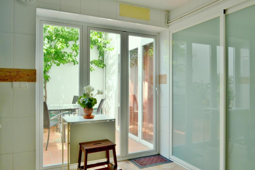 a room with sliding glass doors and a table at SunShine Villa in Córdoba
