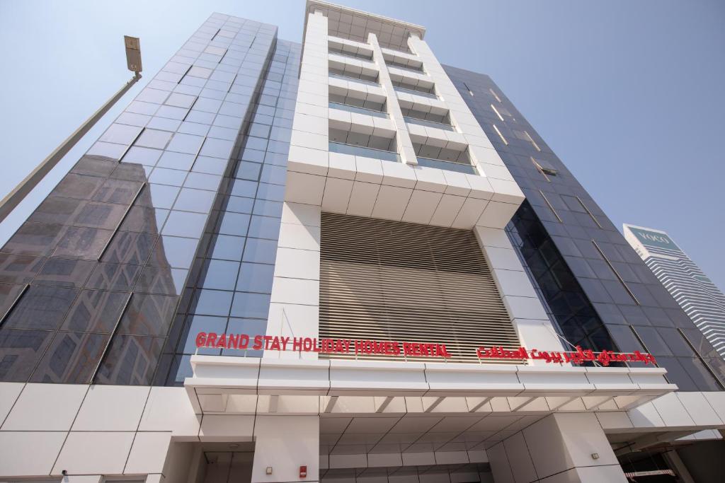 a building with a sign on the front of it at Grand Stay Holiday Homes Rental in Dubai