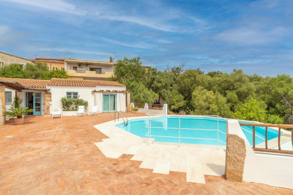 a swimming pool in the backyard of a house at Cozy apartment Lemon San Pantaleo in Olbia