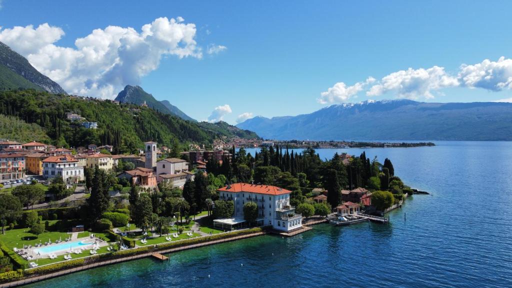 una vista aerea di un resort su un lago di Hotel Bella Riva a Gardone Riviera
