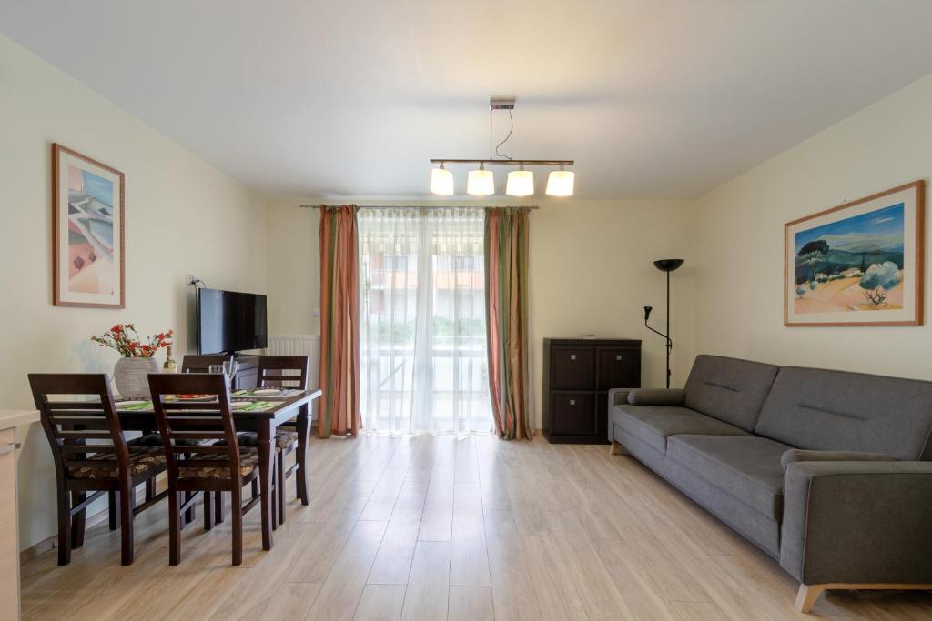 a living room with a couch and a table at TriApart Amber Jantar VII in Jantar