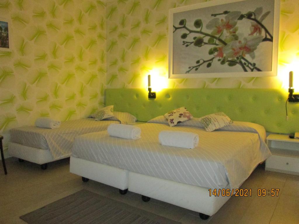 Postel nebo postele na pokoji v ubytování Hotel Tropical