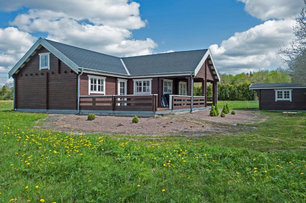 a large wooden house with a large yard at Hovborg Ferieby - Torpet 81 in Hovborg