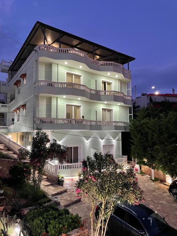 a white building with balconies on the side of it at Relax Apts Saranda in Sarandë