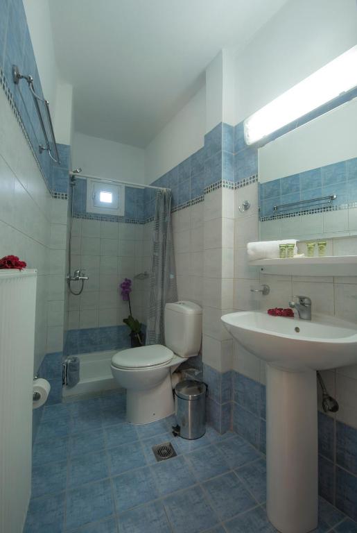 a bathroom with a toilet and a sink at Filoxenia Hotel in Volos