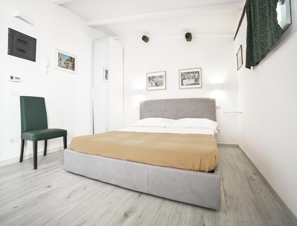 a bedroom with a bed and a chair in it at 55 Florence in Florence