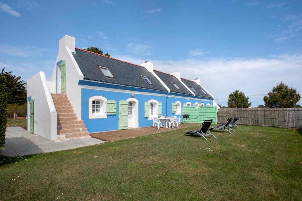 バンゴールにあるMaison de 3 chambres a Bangor a 500 m de la plage avec jardin clos et wifiの青と白の家(テーブルと椅子付)