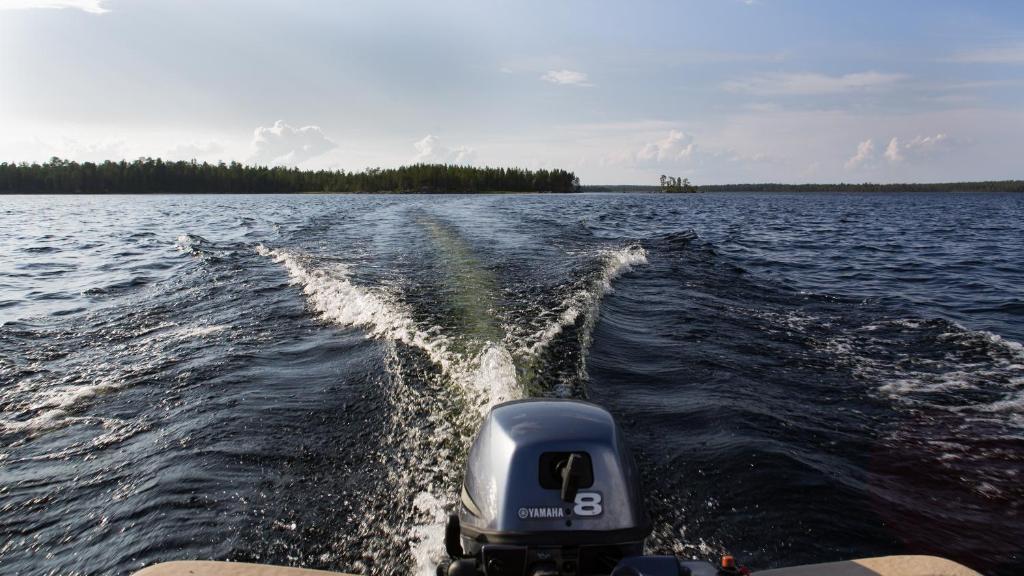 a boat in a body of water at Wilderness Hotel Nellim & Igloos in Inari