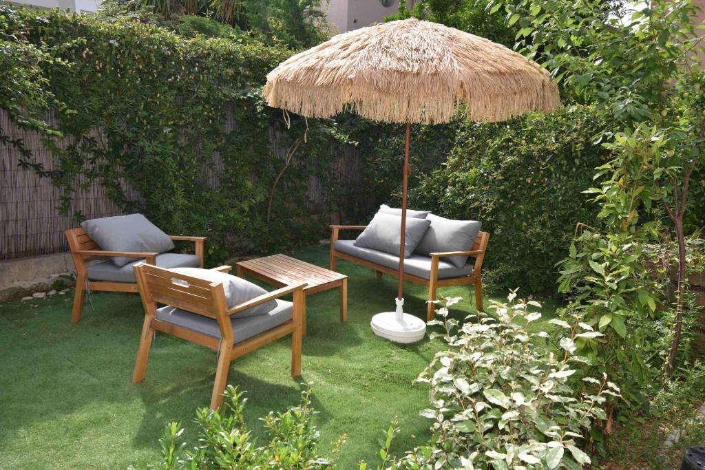 a patio with two chairs and an umbrella at Dana Paradise House in Nice