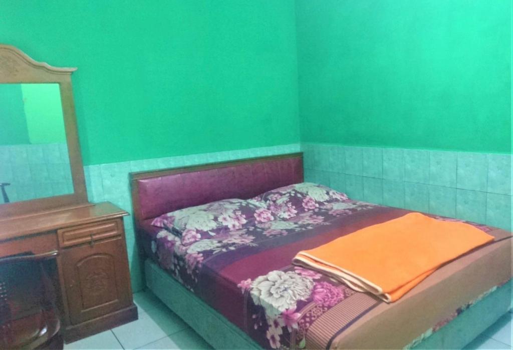 Postel nebo postele na pokoji v ubytování Hotel Bukit Panembahan