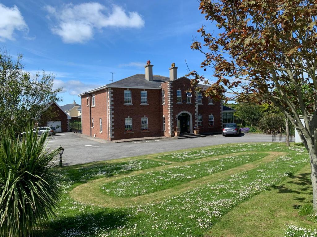 a large red brick building with a driveway at St Martin's, Rosslare Harbour Guest Accommodation in Rosslare