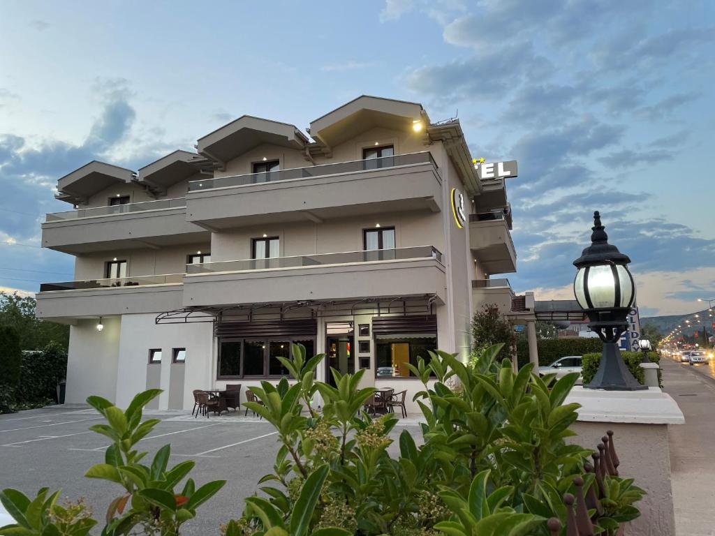 a building with a street light in front of it at Hotel Holiday in Podgorica