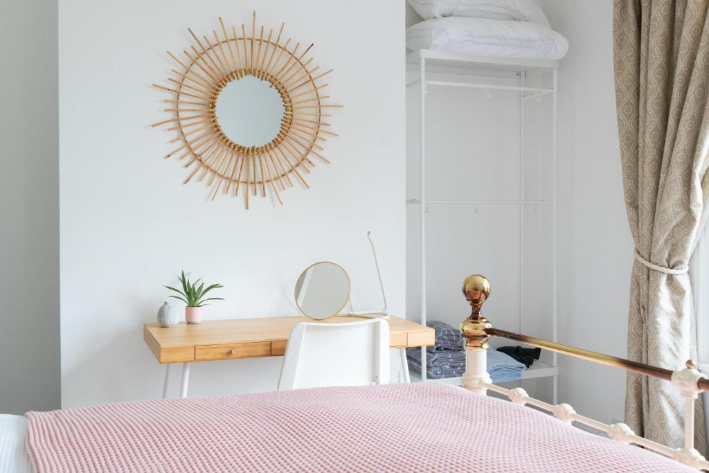 a bedroom with a mirror and a table at Victorian end-of-terrace, Boston Spa in Boston Spa