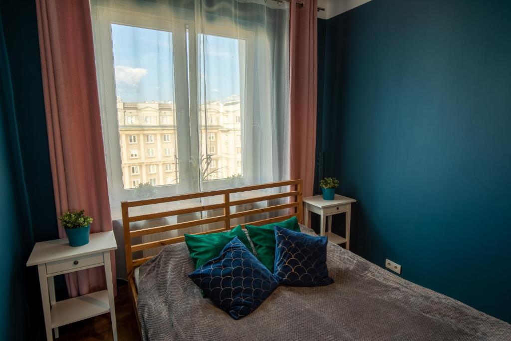 a bedroom with a bed and a large window at Apartament Eliza in Warsaw