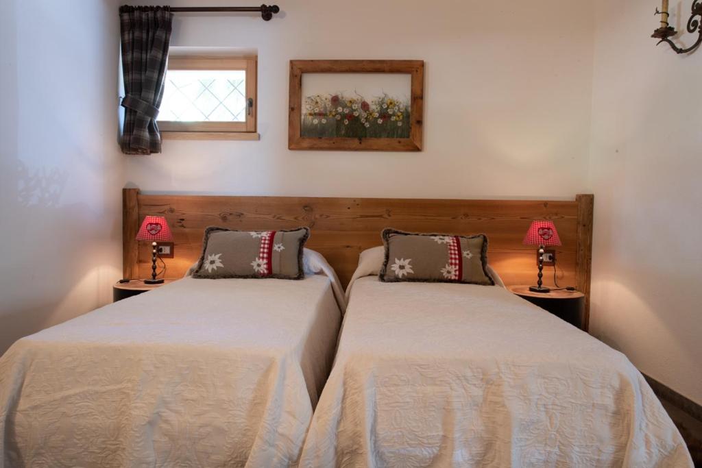 Postel nebo postele na pokoji v ubytování Chalet degli Abeti by AMA Val di Fassa