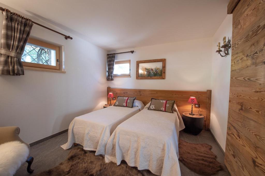 Postel nebo postele na pokoji v ubytování Chalet degli Abeti by AMA Val di Fassa