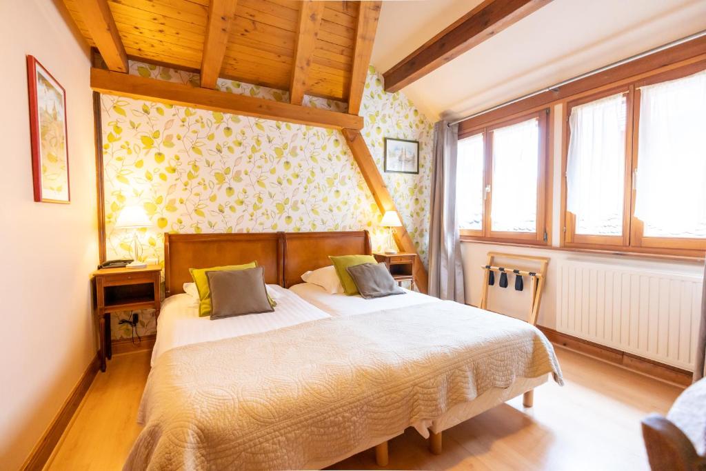Postel nebo postele na pokoji v ubytování Hotel à l'Oriel