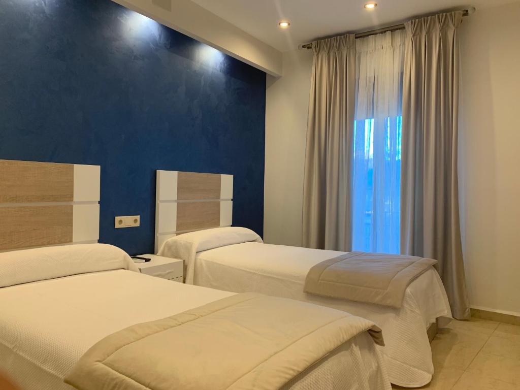Postel nebo postele na pokoji v ubytování Hostal Poeta Machado