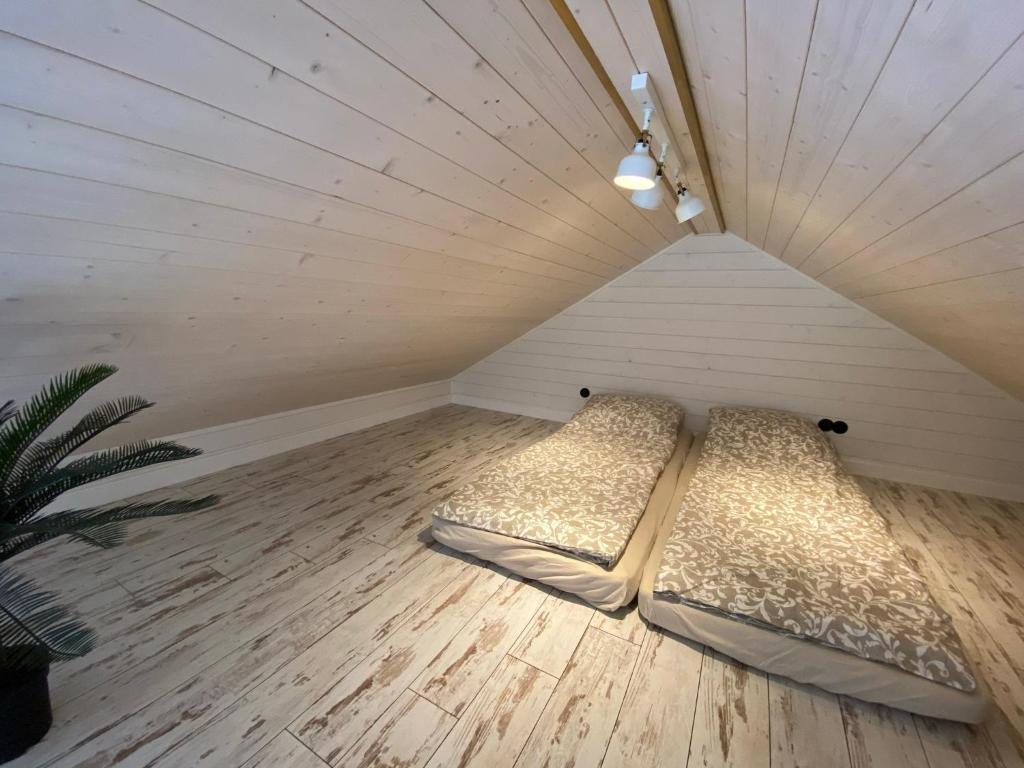 a room with two beds in a attic at Vizbules in Turaida