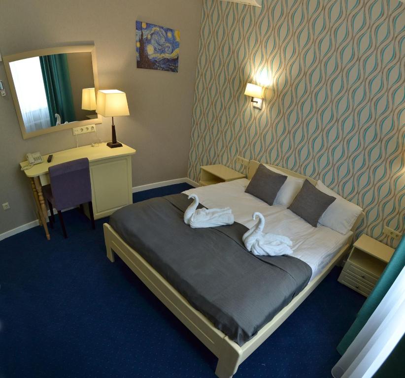 Postel nebo postele na pokoji v ubytování Hotel Ajur