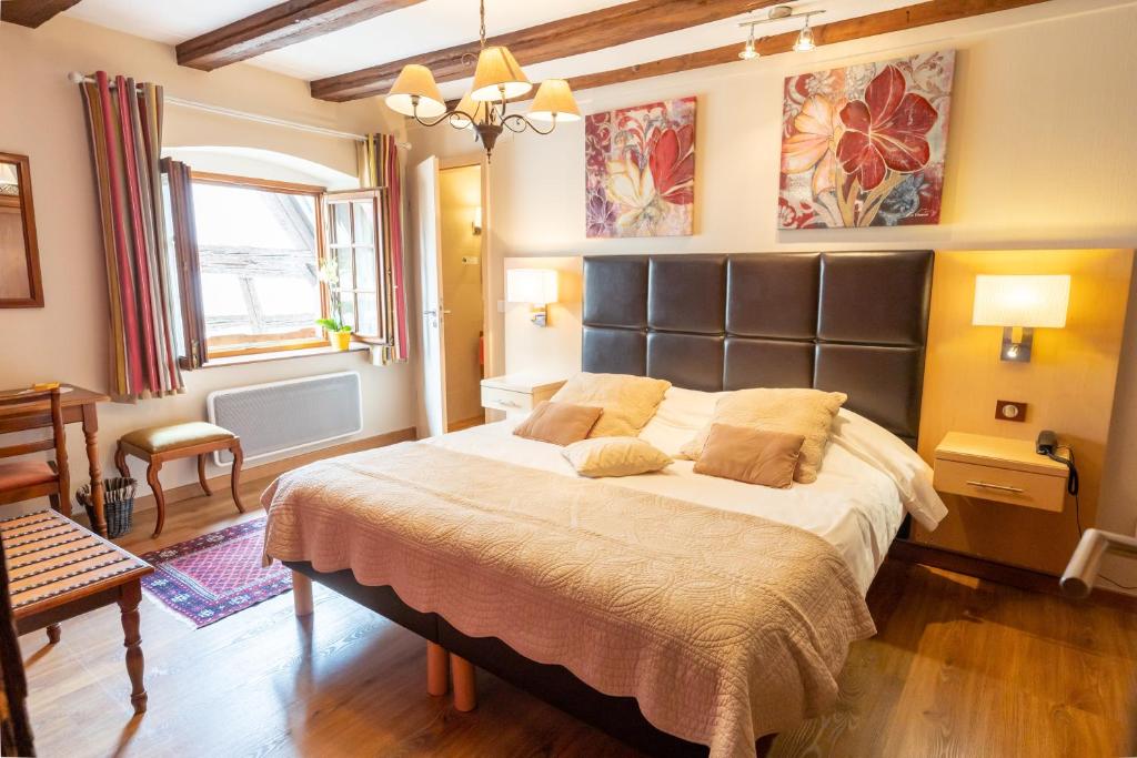 Postel nebo postele na pokoji v ubytování Hotel à l'Oriel