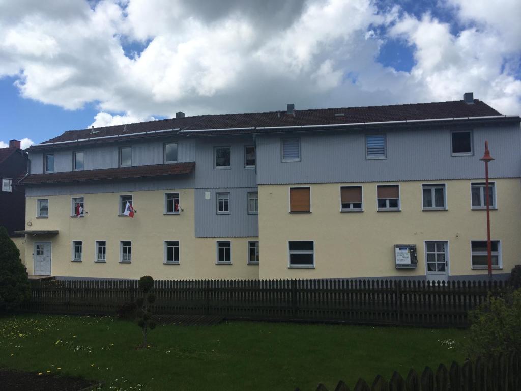 a large white building with a fence in front of it at Rhöner Sternenhimmel FeWo 1 und 2 in Frankenheim