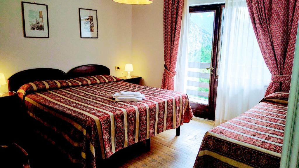 Postel nebo postele na pokoji v ubytování HG Hotel Italia