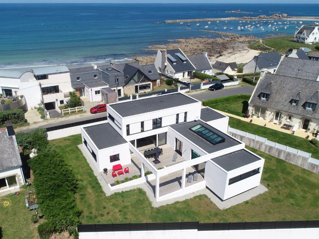 an aerial view of a house with the ocean at Villa Pool and Beach Bretagne in Plouescat
