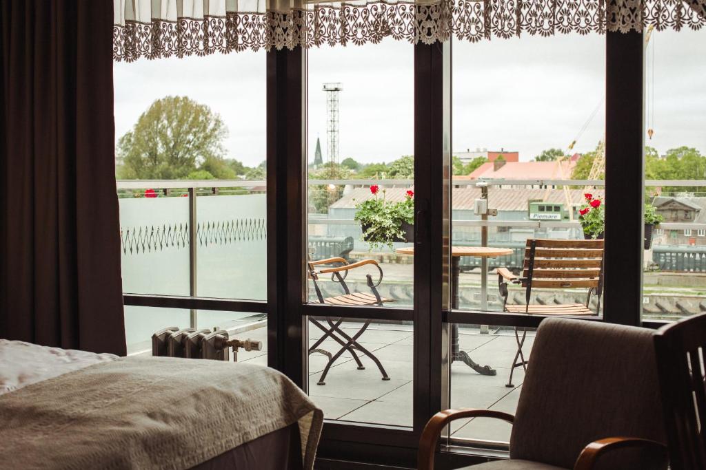 Postel nebo postele na pokoji v ubytování Promenade Hotel Liepaja