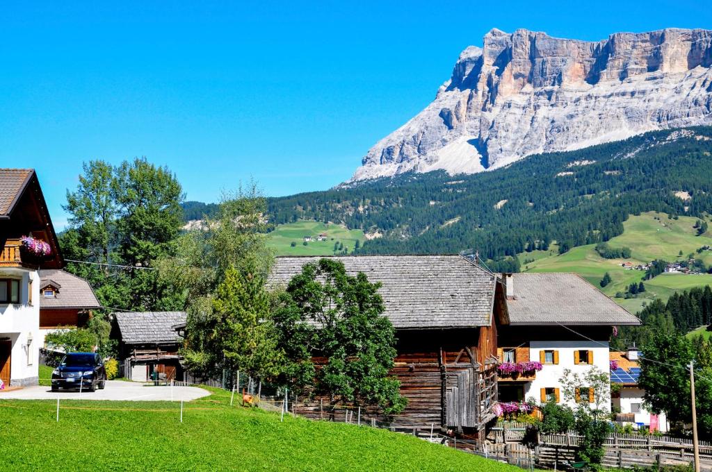 a group of buildings with a mountain in the background at Chalet Funtanacia in La Villa