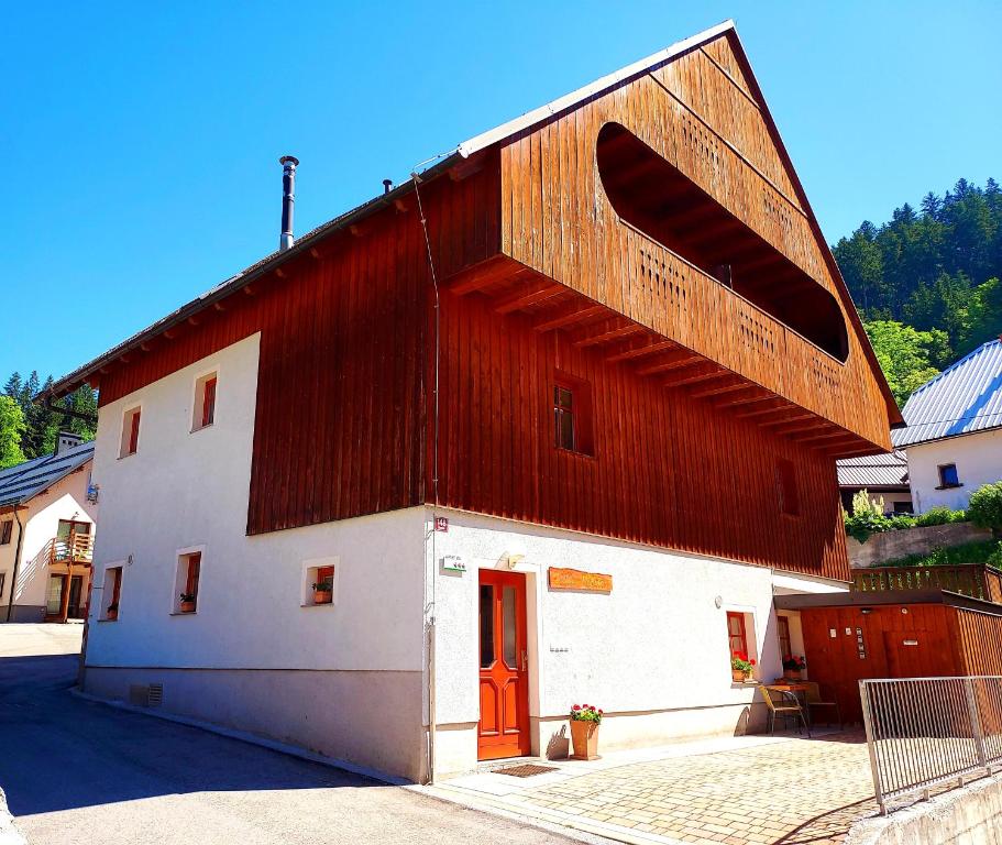 granero grande rojo y blanco con puerta roja en Villa Nebina, en Rateče
