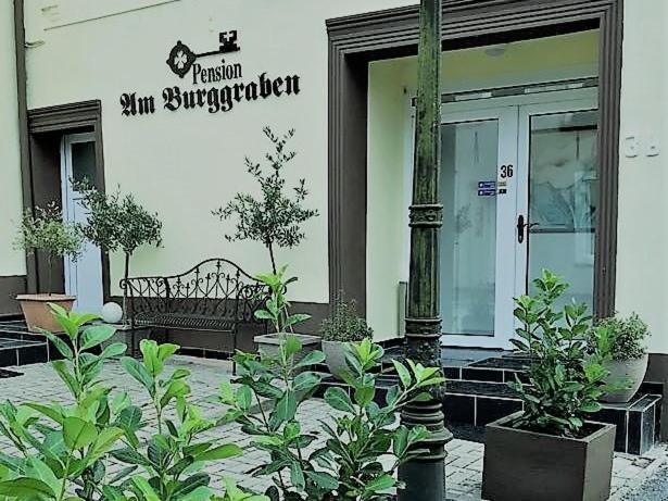 a building with a bench in front of a store at Haus am Burggraben in Hinte