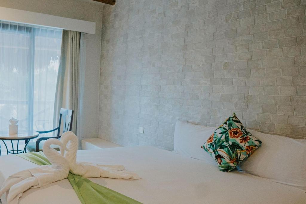 Postel nebo postele na pokoji v ubytování Hotel MAYARI Holbox