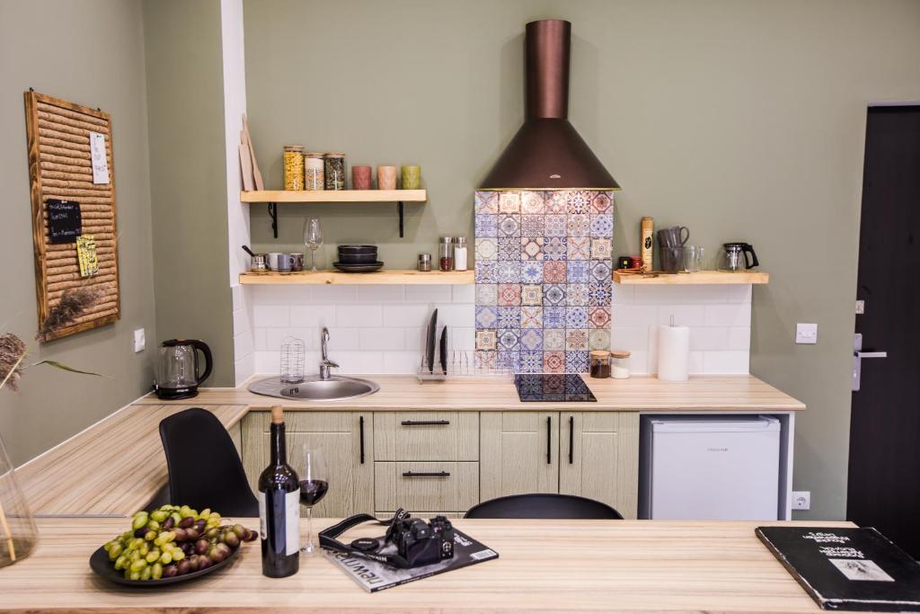 a kitchen with a table with a bowl of fruit at hotelise I Bells-Of-Ireland Apartment in Yerevan