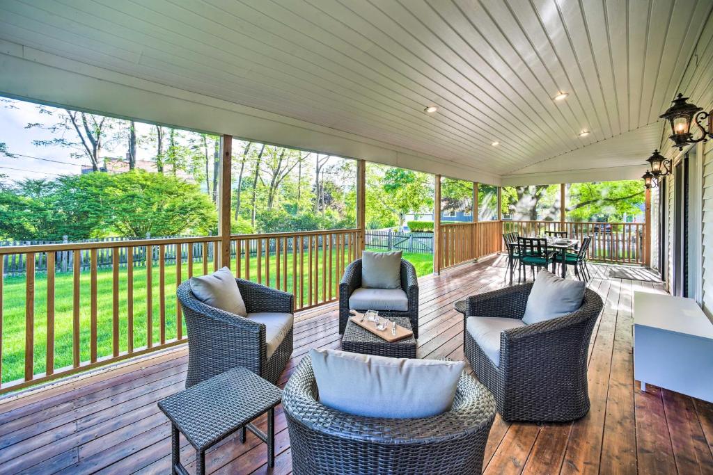 a screened in porch with chairs and a table at Peaceful Family Home with Fire Pit and Large Yard in Williamstown